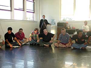 
Performers in "Sethu." Jim Hodges is second from the left. Hodges says learning the art of monkey chanting with his fellow volunteers has been a rich experience. (MPR photo/Chris Roberts)