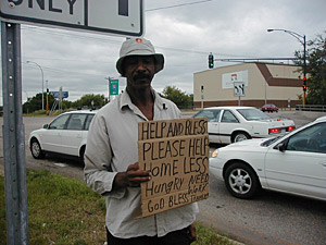 
Charles Williams says passers-by were more generous when the weather was colder.  "Things are bad for me now," he says. "But it's gonna get better, because I believe in God." (MPR Photo/Jeff Horwich)