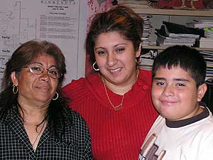 
Lisa Gallegos with her mother and younger brother. Lisa has convinced her mom to register to vote, but Maria Guzman isn't sure her vote can make a difference.  (MPR photo/Dan Gunderson)
