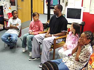 
Brandon Phillips leads his fourth grade students through a morning meeting. (MPR Photo/Tim Pugmire)