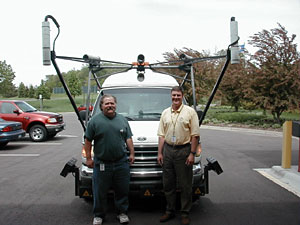 
MnDOT Pavement Data Manager Dick Ruud, left, and Pavement Management Engineer Dave Janisch stand in front of the pavement quality measurement van. (MPR Photo/Dan Olson)