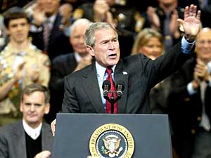 
President waves to the crowd during a campaign rally Friday in Manchester, New Hampshire. Bush also campaigns in Ohio Friday, and holds a rally in Minneapolis Saturday afternoon. (Photo by STEPHEN JAFFE/AFP/Getty Images)