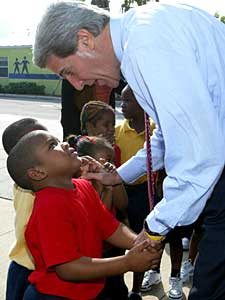 
Democratic presidential candidate John Kerry greets a child from Nap Ford Community School Friday in Orlando, Florida, on his way to give a campaign speech. Kerry is scheduled to campaign across Florida before flying to Wisconsin.  (Photo by Justin Sullivan/Getty Images)