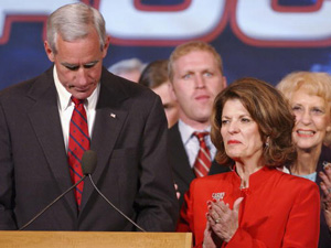 
Colorado Republican candidate Pete Coors lowers his head with his wife Marilyn and family next to him, November 2, 2004 in Denver, Colorado. Coors conceded the race against his opponent Ken Salazar late Tuesday night. (Photo by Thomas Cooper/Getty Images)