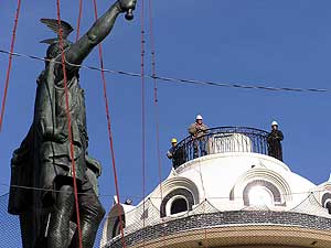 
A crowd watched as a crane lifted the newly restored statue skyward. (MPR photo/Mark Steil)