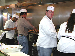 
Employees at the restaurant, including co-owners Adel Hegazi (tan shirt) and Shaker Elsaied (face to camera), are busy preparing food before sundown, when the customers will arrive.  (MPR Photo/Julie Siple)