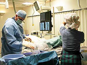 
Staff at Abbott Northwestern Hospital finish up after a procedure to open a patient's clogged coronary artery with a tiny metal scaffold called a stent. (MPR Photo/Bill Catlin)