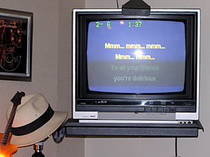 
The lyrics to karaoke tunes scroll across the TV screen.
 (MPR Photo/Annie Baxter)