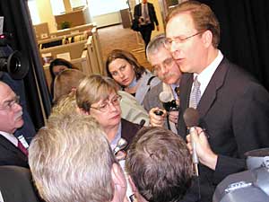 
House DFL Leader Matt Entenza, surrounded by reporters, again criticized Pawlenty's refusal to consider raising taxes to pay for some services.  "The governor's vision isn't good enough for Minnesota," Entenza said. (MPR Photo/Laura McCallum)