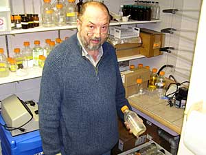 
Bemidji State University environmental science professor Dr. Drago Bilanovic holds a glass bottle containing xanthan, a product extracted from fermented potato waste. Bilanovic and other BSU researchers are looking for ways to convert potato waste into valuable and environmentally friendly materials. (MPR photo/Tom Robertson)