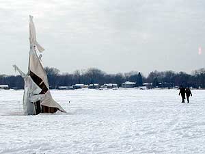 
Art lovers Lilian and Howard Rand suffer for their art as they traipse across Medicine Lake from one art shanty to the next.  (MPR Photo/Marianne Combs)