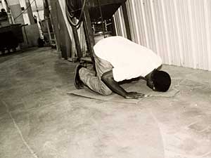 
Mustafa Luguf is a devout Muslim from Somalia who prays five times daily. During his 20-minute break, he washes his hands, then walks behind the assembly line where he works, puts a piece of cardboard on the floor and prays to Allah, facing east. Few people know he does this. "Everything I do is for God. Some people come here and they change. I always respect my religion and my culture." (Photo courtesy Meg Luther Lindholm)