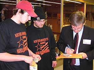 
Patrick Thompson, a high school student from Warroad, sold t-shirts at the meeting that read, "Northern Minnesotans Against DNR Land Barons." Thompson says the DNR's plan would make it tough to get to some parts of the woods for hunting.
 (MPR Photo/Tom Robertson)
