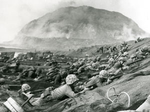 
Fifth Division Marines land on Iwo Jima, with Mt. Suribachi in the background on D-Day, February 19, 1945. (Photo: Lou Lowery, from the collection of Charles Lindberg)