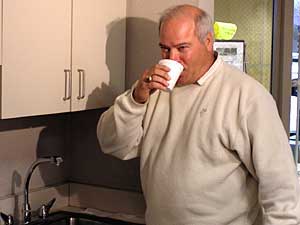 
The mayor of Oakdale, Carmen Sarrack, took a drink of water during a news conference in January, 2005, to prove his city's water supply is still safe, even though it's been contaminated with low levels of PFOS and PFOA. (MPR Photo/Lorna Benson)