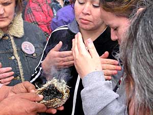 
People attending the event gathered in a circle, while tribal elders burned sage and smoked ceremonial pipes.   (MPR Photo/Bob Reha)