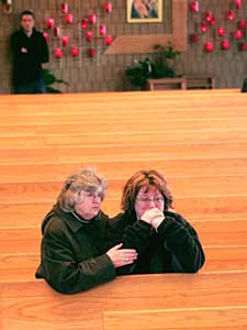 
Karen Allen, right, a registered nurse at Red Lake Hospital, is comforted by a friend at St. Philip Church following the memorial service.  (Photo by Scott Olson/Getty Images)