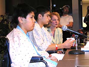 
Lance Crowe, left, and Cody Thunder, appear at a news conference at the Bemidji hospital.  Hospital administrator Sherri Birkeland is in the background. (MPR Photo/Bob Reha)