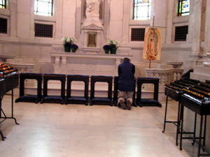 
A person prays for the pope on Friday afternoon at the Cathedral of St. Paul. (MPR Photo/Bianca Vazquez Toness)