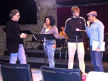 
Michael Korie discusses the score with Anna Jablonski and Raymond Ayres talks with Ricky Ian Gordon as they rehearse a scene from the first act. Jablonski plays Ma Joad and Ayres plays Tom Joad.     (MPR photo/Karl Gehrke)