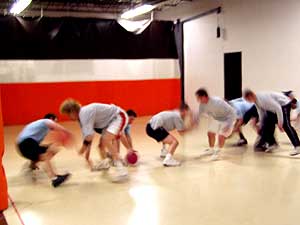 
Players scramble at the start of a dodgeball game at the Dodge-it Dodgeball Center in Minneapolis.      (MPR Photo/Toni Randolph)