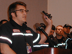 
Ted Ludwig, president of Local 33 of the Aircraft Mechanics Fraternal Association, is among those told his job will be eliminated. Here he holds up airplane parts at a press conference following earlier an job cut announcement last month. (MPR File Photo/Jeff Horwich)