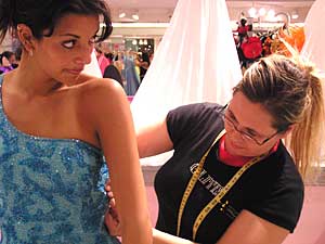 
Cindy Bradley tries on a prom dress at Glitz. She returned to the store to buy the dress after shopping for two months online and in stores.  (MPR Photo/Bianca Vazquez Toness)