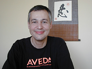 
Dominique Conseil, seen here in his office in Blaine, has been Aveda's president since 2000 -- about the time Aveda's research into Japan began.  Conseil himself has lived for six years in Japan. Behind him is the Japanese symbol for "patience." (MPR Photo/Jeff Horwich)