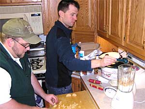 
Todd Foster and Scott Miller are preparing food for their canoe trip to Hudson Bay.  They figure it will take them 110 days to reach their final destination.  (MPR Photo/Tim Post)