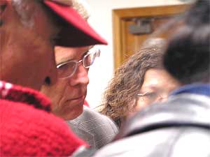 
After the official testimony concluded, several parents approached Sen. Dorgan (center) to tearfully share their personal stories of a lost son or daughter. 
 (MPR Photo/Dan Gunderson)