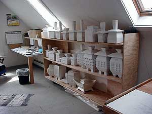 
Royce has made dozens of urns, which are ready for sale if he can find the clients. For now they sit in his attic, his basement, his first floor showroom, and his garage. (MPR Photo/Marianne Combs)