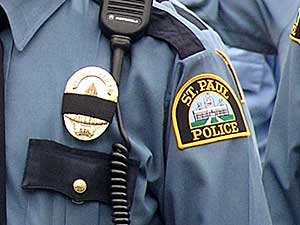 
St. Paul police officers wear black bands around their badges as a sign of mourning. (MPR Photo/Bianca Vazquez Toness)