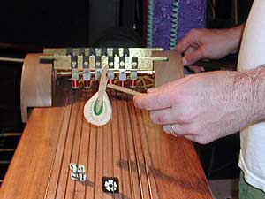 
Playing the Cleophone. Krejci uses piano hammers, bows, brushes, even bones on the strings, each drawing a different sound. (MPR photo/Chris Roberts)