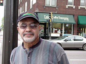 
Nathanial Khaliq points to restored Victorian homes and recalls the days when they were abandoned or gang headquarters. (MPR Photo/Marisa Helms)