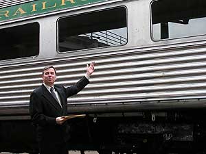 
Ken Buehler runs the Duluth and North Shore Scenic Railroad, a tourist rail line operated out of the historic Depot in downtown Duluth.  Buehler is standing beside the railroad's Budd car, which is being used in the transit demonstration. (MPR Photo/Bob Kelleher)