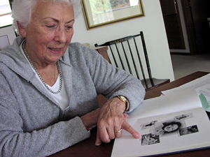 
Jeanne Bearmon thumbs through some of her World War II photos. (MPR photo Elizabeth Stawicki)