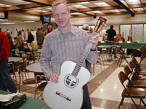 
Phil Heywood performs each year at the program's graduation.  He plays short songs on several of the newly hatched instruments. (MPR Photo/Erin Galbally)