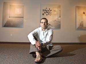 
Anthony sits. He says if nothing else, the prospect of taking pictures at these apartments has turned his day job into a treasure hunt. (Image courtesy of Augsburg College)
