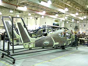 
Plastic airplane parts are manufactured in Grand Forks, North Dakota, and assembled in Duluth, Minnesota.  Here two airplane halves are prepared to be bonded into a single unit. (MPR Photo/Bob Kelleher)