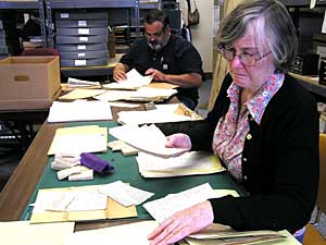 
New York Academy of Medicine Conservator Susan Martin helps White Earth Tribal Archivist Andy Favorite sort through stacks of historic tribal land documents. The faded records date from about 1904 through the mid-1930s.  (MPR photo/Tom Robertson)