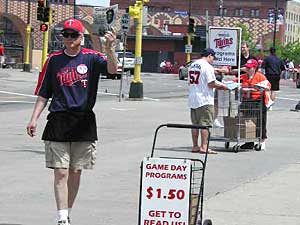 
Twins Magazine and Gameday vendors work side by side outside the Metrodome. (MPR Photo/Jim Bickal)