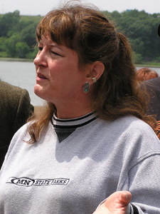 
Fort Snelling Park ranger Sharon Decker stood in front of the boat launch at the park and talked about the many people who have reservations to camp at the state parks over the July Fourth weekend.  She says those people  won't be able to enjoy the natural resources at 72 parks and recreation areas if a shutdown occurs.  (MPR Photo/Tom Scheck)