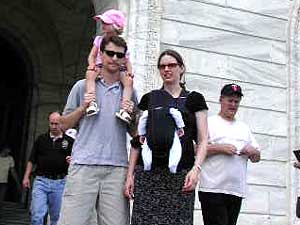 
Jon Osmond and his young family showed up at the rally. Osmond works for MnDOT. He says most of his colleagues believe in public service. "I feel like we're getting screwed," he says. (MPR Photo/Art Hughes)