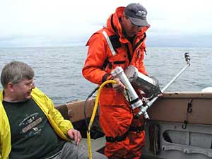 
Jerry Eliason (left) watches as Randy Beebe prepares the underwater camera which took the picture seen below.  (Photo courtesy Lake Superior Magazine)