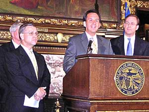 
Johnson, Pawlenty, Sviggum and other lawmakers announce a budget deal in the early hours of July 9. (MPR file photo)