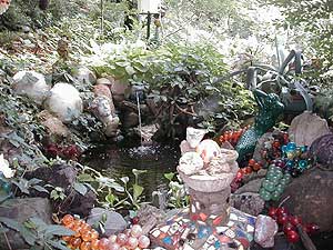 
Judyland is filled with clusters of objects like these placed around a tiny waterfall.  Onofrio's especially fond of bowling balls and they're scattered around her sprawling backyard garden. (MPR Photo/Erin Galbally)