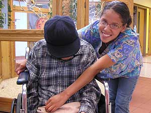 
Red Lake band member Debra Goodwin, 18, grew up in Bemidji, but says her heart has always been with the Red Lake community. Goodwin works at the elderly care facility in Red Lake. She's pictured with Francis, one of the facility's residents. (MPR photo/Tom Robertson)