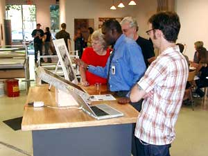 
Donovan Durham explains a picture to people attending the opening. (MPR Photo/Marianne Combs)
