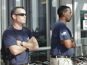 
Security personnel hired by Northwest Airlines keep a watch on things. (MPR Photo/Jeff Horwich)