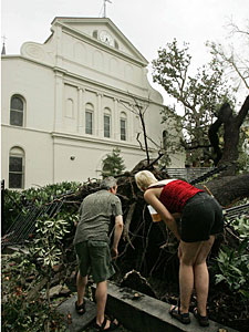 
 People view downed trees in the courtyard of the historic Saint Louis Cathedral in the aftermath of Hurricane Katrina. (Photo by Mario Tama/Getty Images)